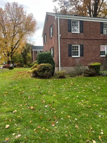 a view of a house with a yard and plants