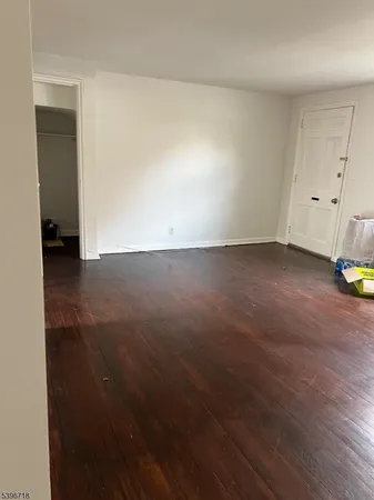 an empty room with wooden floor