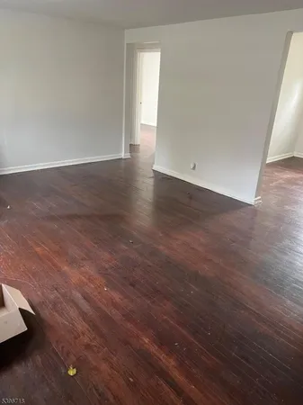 an empty room with wooden floor
