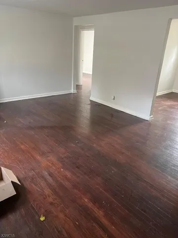 an empty room with wooden floor