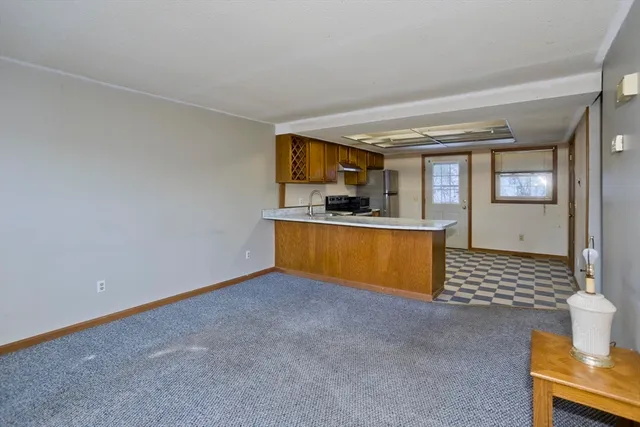 a kitchen with stainless steel appliances granite countertop a sink and a stove next to a window