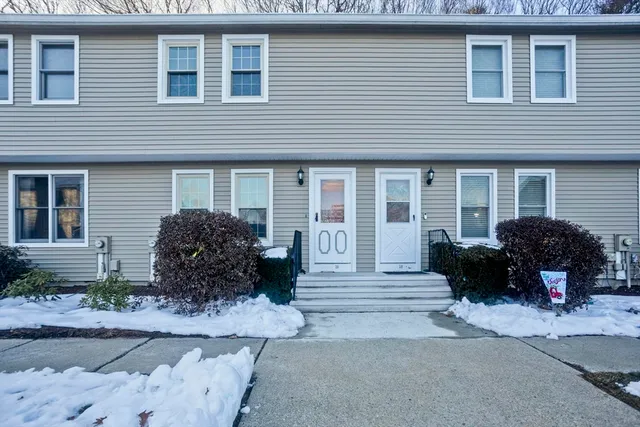 a view of a house with a yard and plants