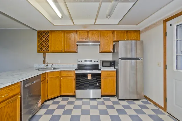 a kitchen with stainless steel appliances granite countertop a refrigerator and a sink