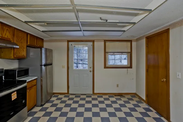 a view of a refrigerator in kitchen and wooden floor