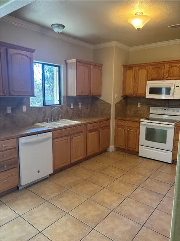 a kitchen with stainless steel appliances granite countertop a sink and cabinets