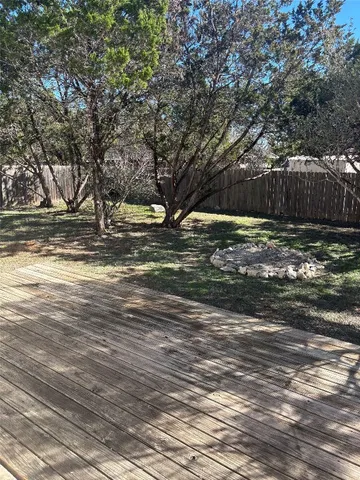 a view of a yard with large trees
