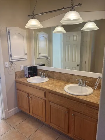 a bathroom with a double vanity sink and a mirror