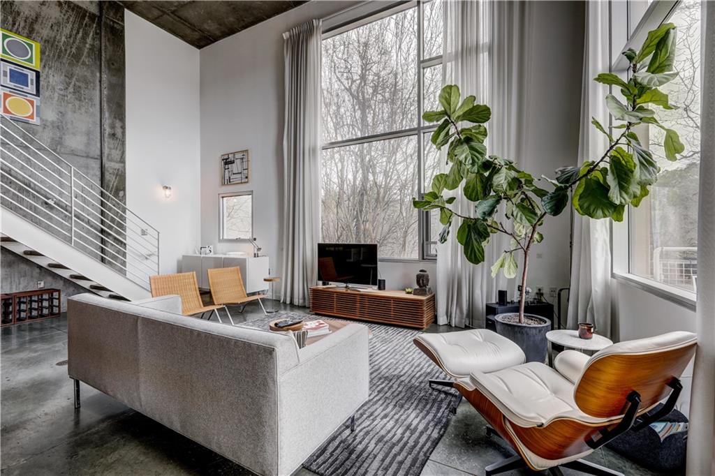 a living room with furniture a fireplace and a potted plant