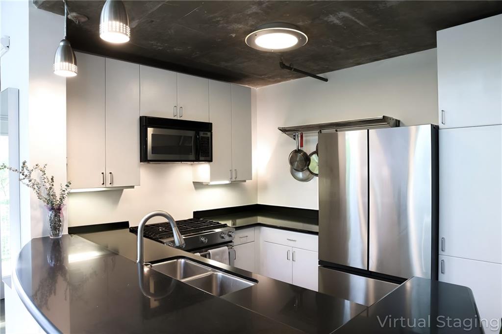 850 Ralph McGill Boulevard Northeast, Unit 30 Atlanta, GA 30306 - Photo 7 of 21 a kitchen with stainless steel appliances a refrigerator and a view of living room