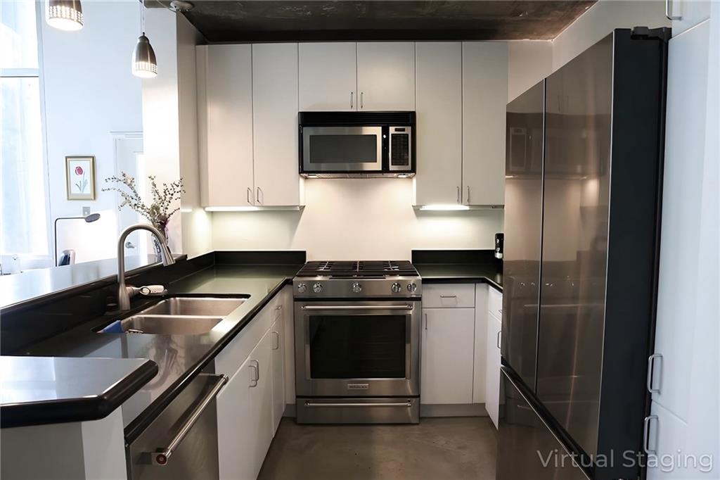 850 Ralph McGill Boulevard Northeast, Unit 30 Atlanta, GA 30306 - Photo 8 of 21 a kitchen with stainless steel appliances granite countertop a sink stove and refrigerator