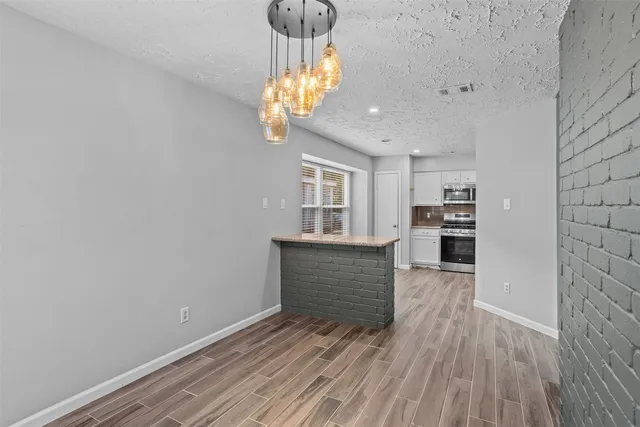 a view of kitchen and dining room with wooden floor