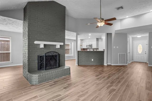 a view of a kitchen and a fireplace