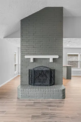 a bedroom with a bed and a fireplace