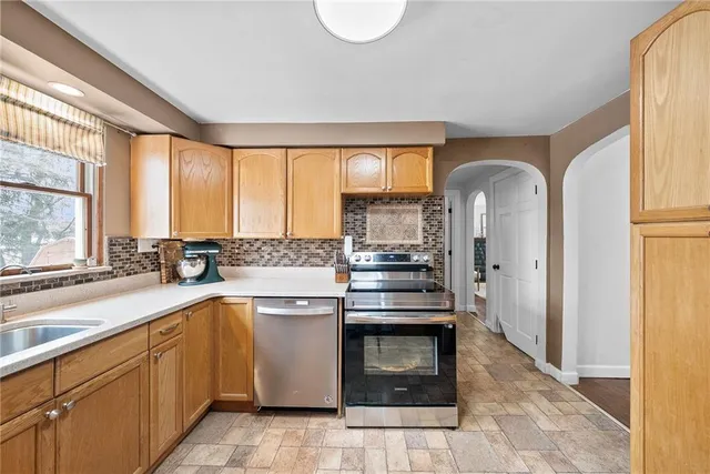 a kitchen with a sink stove and cabinets