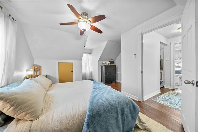 a bedroom with a large bed and a chandelier