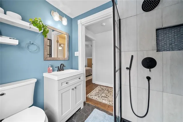 a bathroom with a toilet sink and mirror