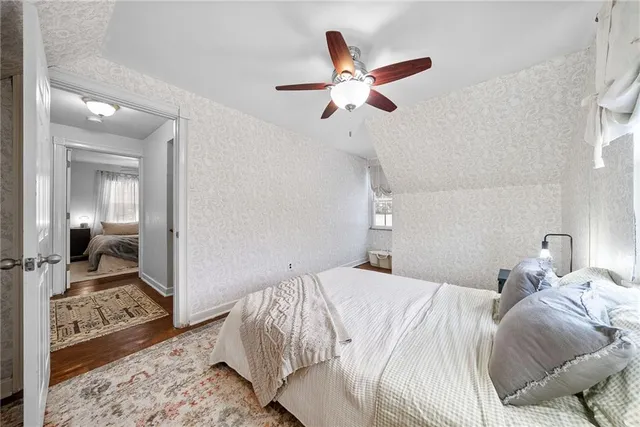 a bedroom with a bed and glass door