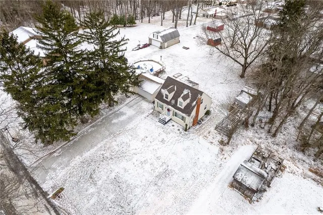 a view of a park with snow on the road