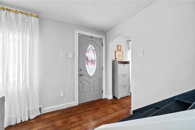 a view of a room with wooden floor and hallway