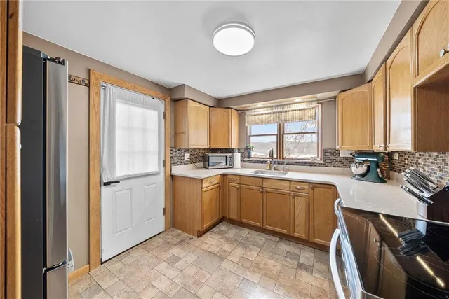a kitchen with sink cabinets and refrigerator
