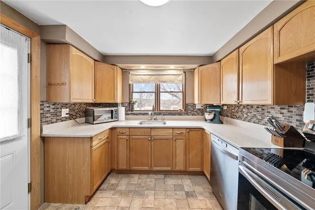 a large kitchen with a sink and cabinets