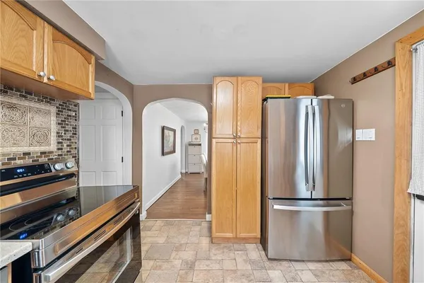 a kitchen with stainless steel appliances a refrigerator and a stove top oven