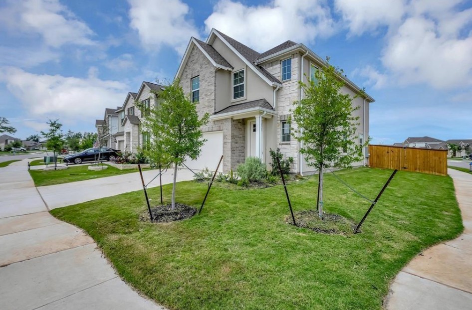 300 Old Trinity Way Georgetown, TX 78628 - Photo 1 of 16 Traditional home with stone siding, stucco siding, an attached garage, driveway, and a residential view