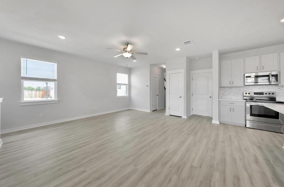 300 Old Trinity Way Georgetown, TX 78628 - Photo 16 of 16 Kitchen with stainless steel appliances, a ceiling fan, recessed lighting, open floor plan, and light wood-style floors