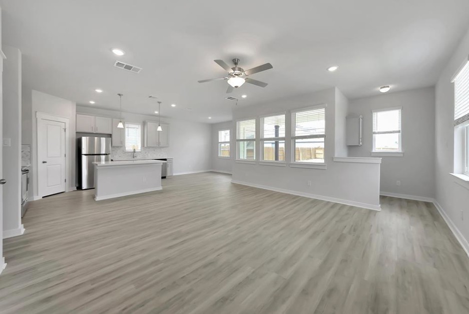 300 Old Trinity Way Georgetown, TX 78628 - Photo 3 of 16 Unfurnished living room with a ceiling fan, light wood-type flooring, and recessed lighting