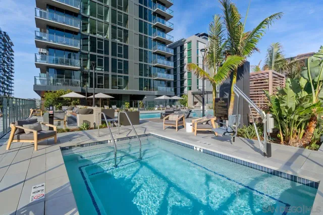 a living room with furniture a large window and a table