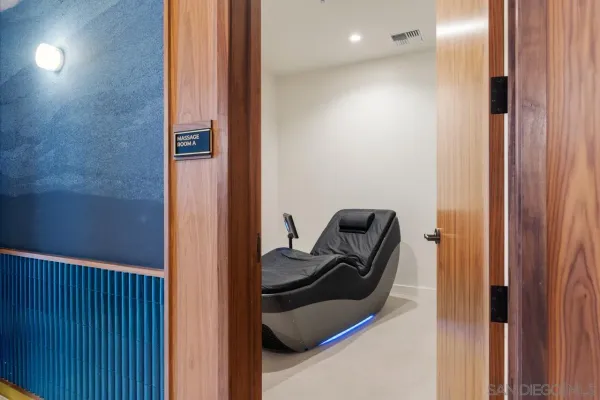 a gym room with gym equipment and a large mirror