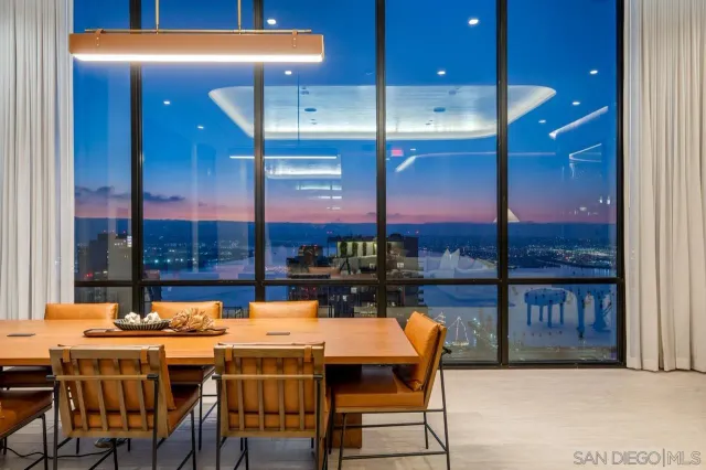 an aerial view of a residential apartment building with a city skyline