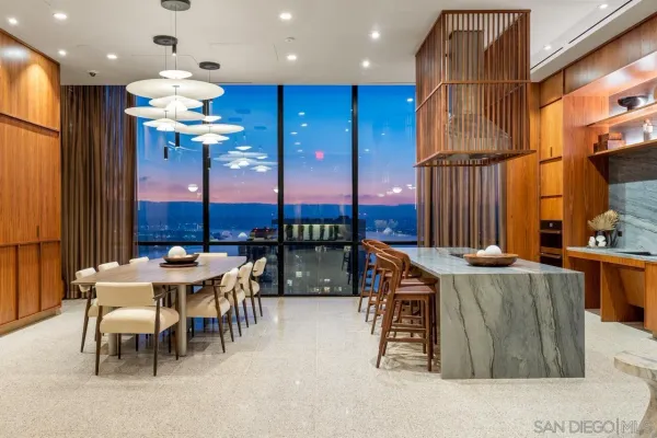 a dining room with furniture and a large window