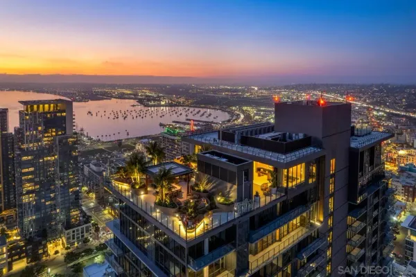 a view of a patio with table and chairs potted plants with wooden floor and fence