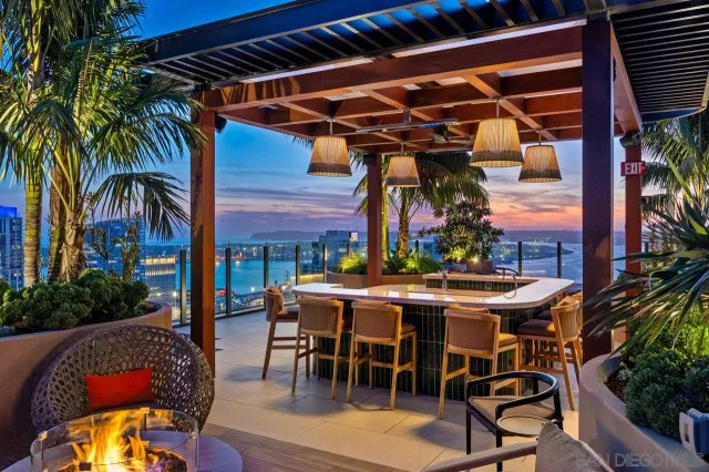 a living room with furniture and floor to ceiling window