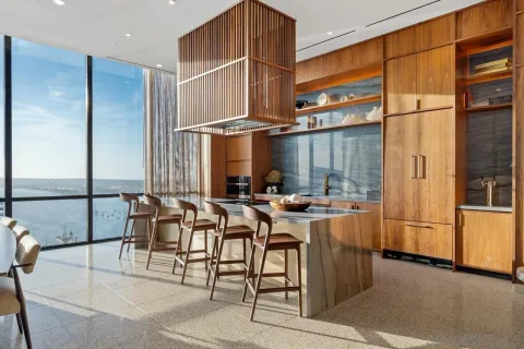 a bedroom with a bed a lamp and large window