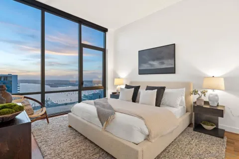 a large kitchen with kitchen island a large counter space a sink appliances and a large window