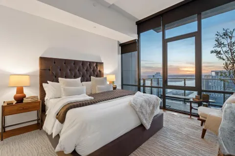 a kitchen with stainless steel appliances granite countertop a stove a sink dishwasher a microwave oven and a dining table with wooden floor