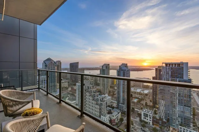 a kitchen with stainless steel appliances granite countertop a stove top oven a sink dishwasher a dining table and chairs with wooden floor