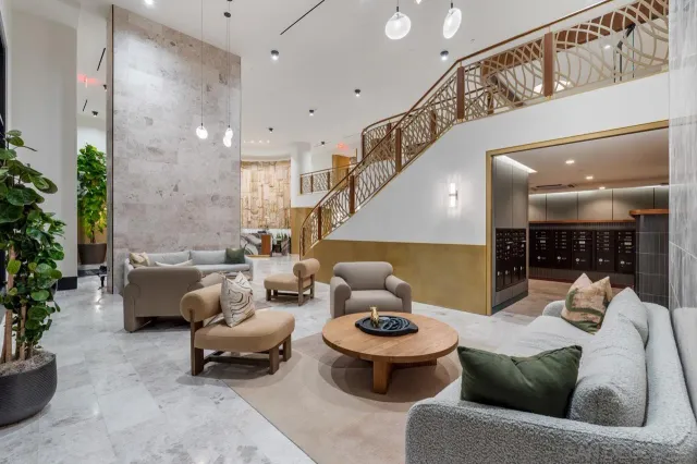 a living room with furniture and a potted plant