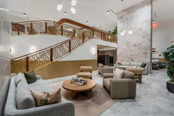 a living room with furniture and a chandelier