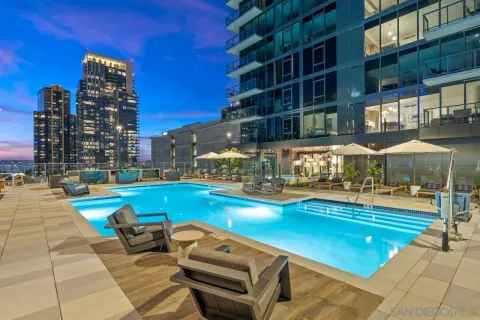 a view of a dining room and hall with kitchen view