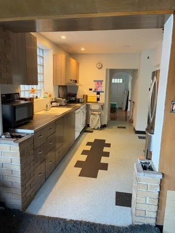 a kitchen with a sink appliances and cabinets