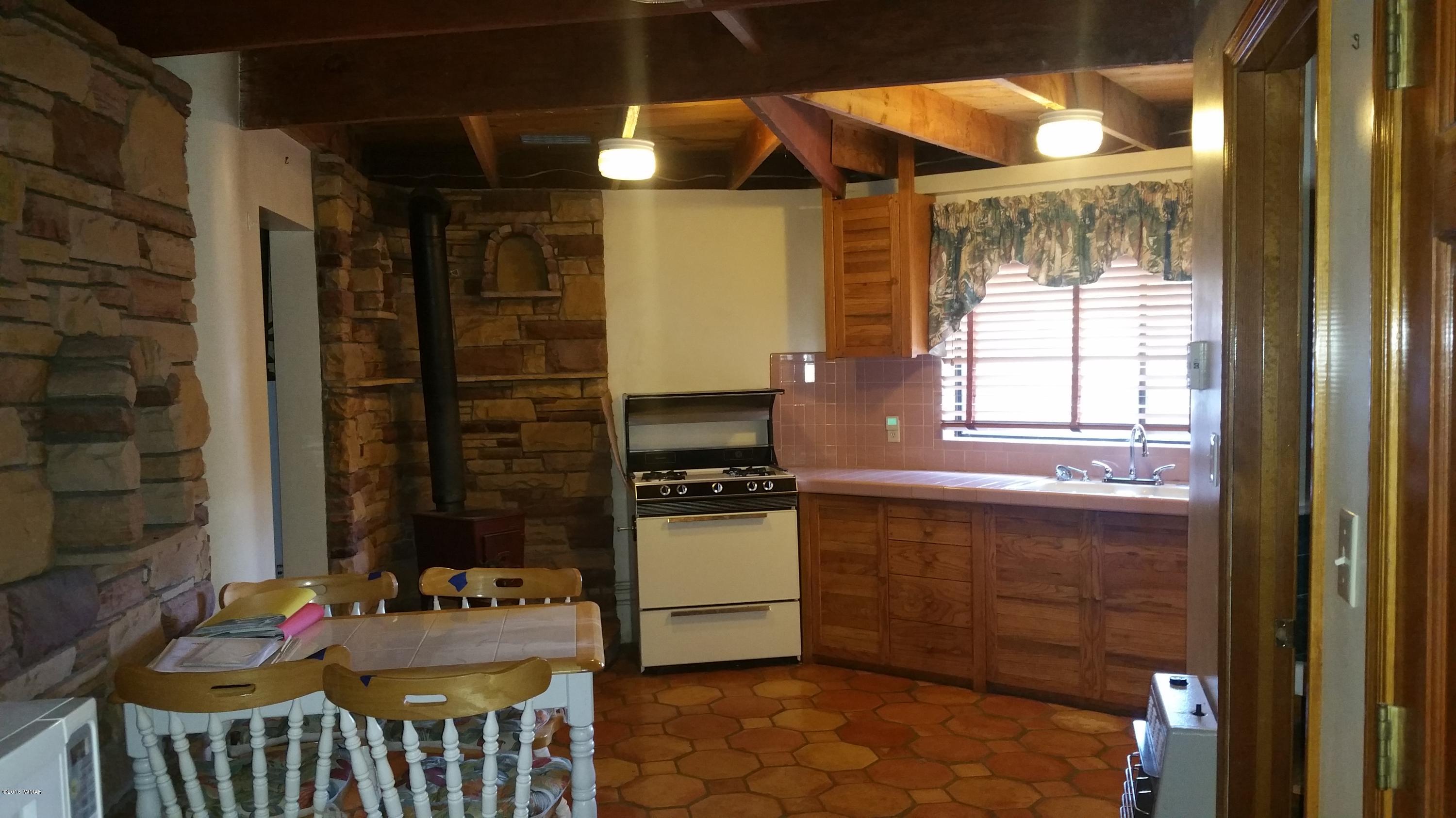 5139 Garibaldi Road Snowflake, AZ 85937 - Photo 11 of 39 a kitchen with a refrigerator and a stove