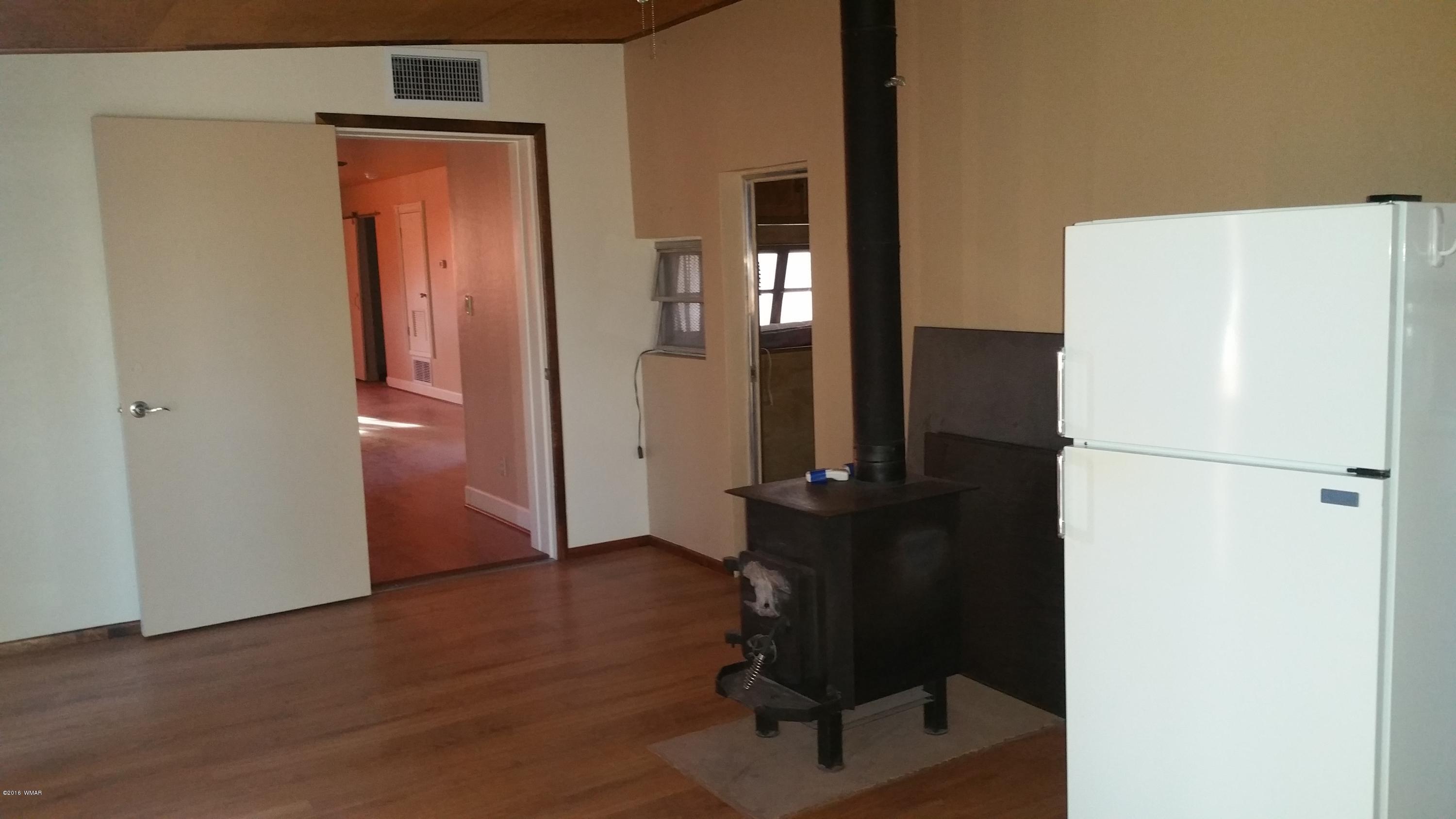 5139 Garibaldi Road Snowflake, AZ 85937 - Photo 22 of 39 a view of a hallway with wooden floor and furniture