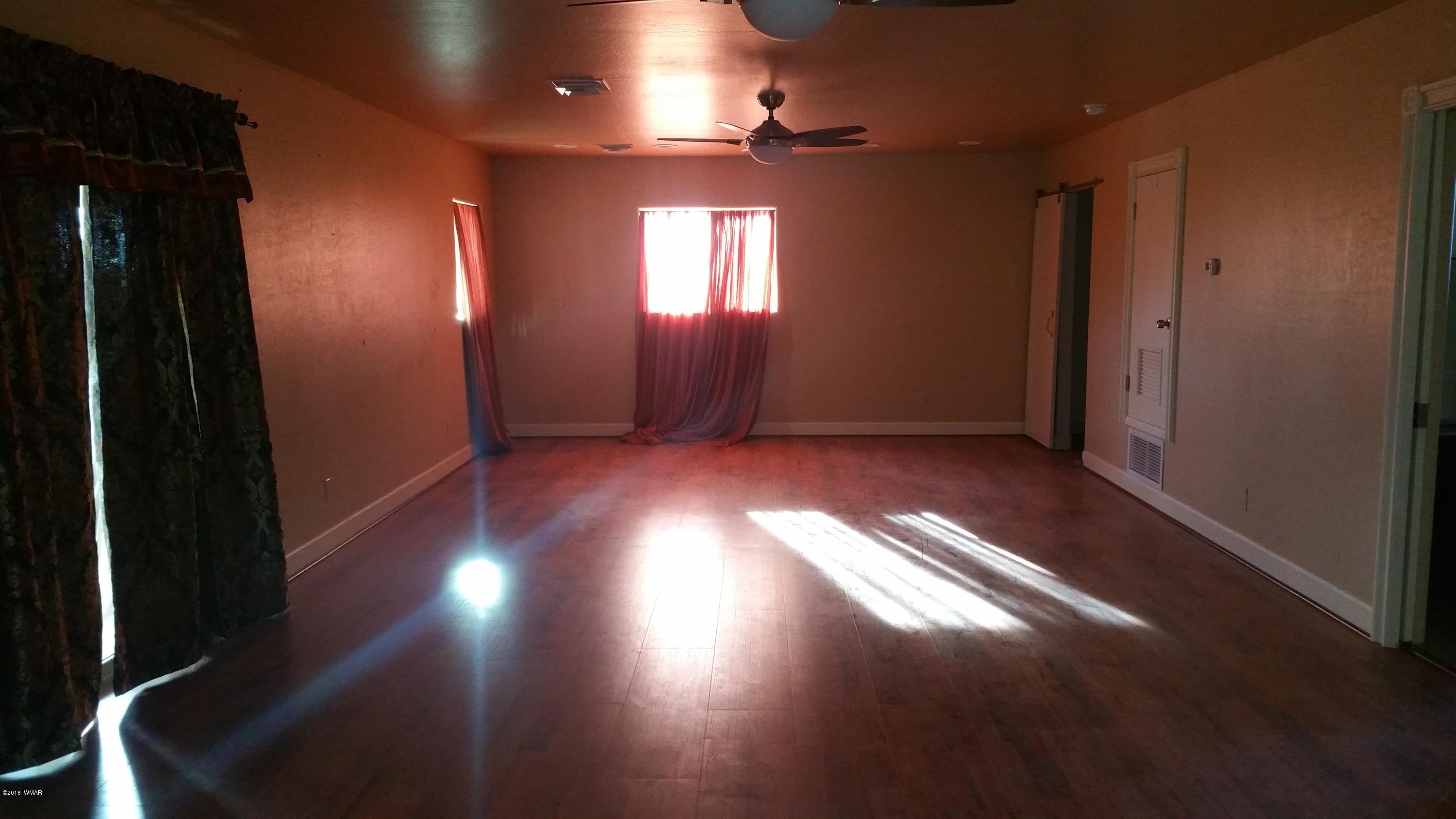 5139 Garibaldi Road Snowflake, AZ 85937 - Photo 28 of 39 an empty room with wooden floor and windows