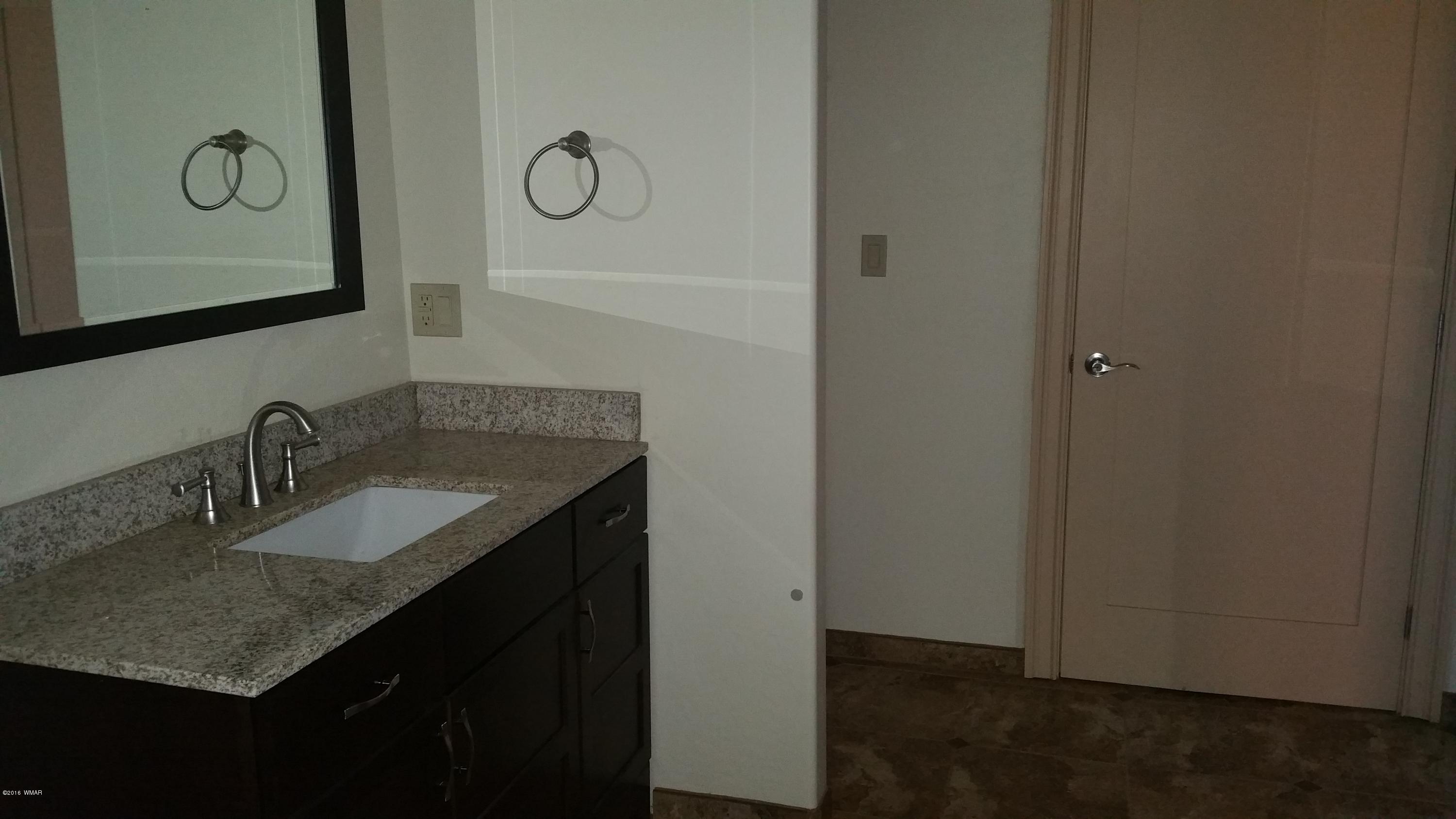 5139 Garibaldi Road Snowflake, AZ 85937 - Photo 34 of 39 a bathroom with a granite countertop sink vanity and mirror