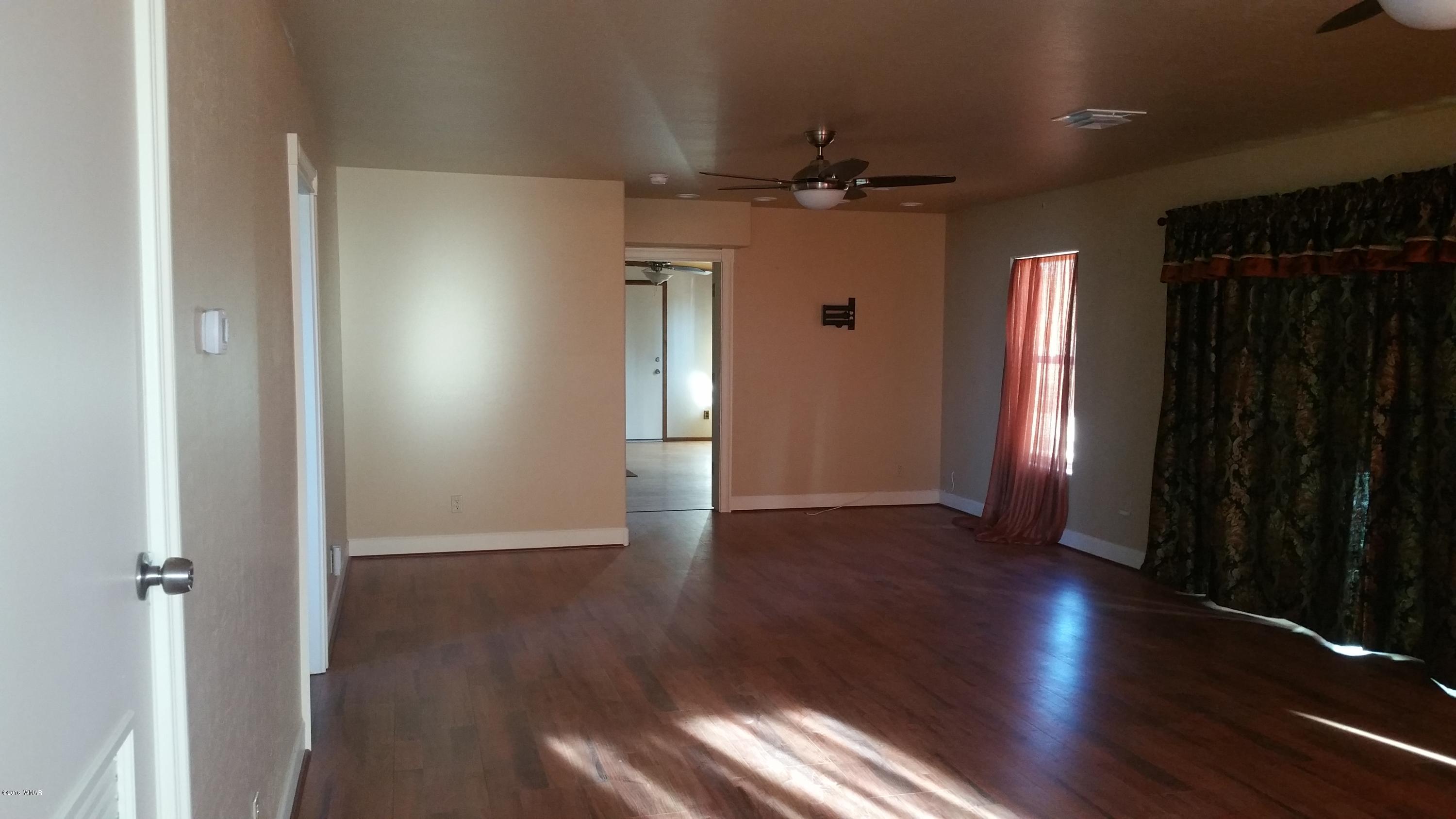 5139 Garibaldi Road Snowflake, AZ 85937 - Photo 37 of 39 an empty room with wooden floor closet and windows