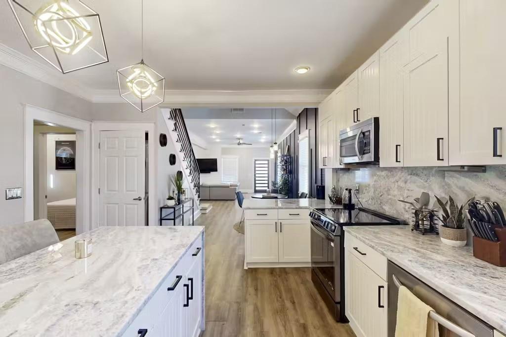153 Randolph Street Northeast Atlanta, GA 30312 - Photo 12 of 37 a kitchen with granite countertop a sink appliances cabinets and furniture