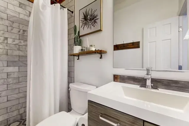 a bedroom with a bed and a mirror